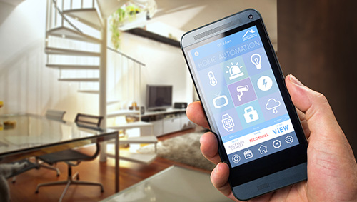 Handy in der Hand zur Bedienung einer Smart Home App